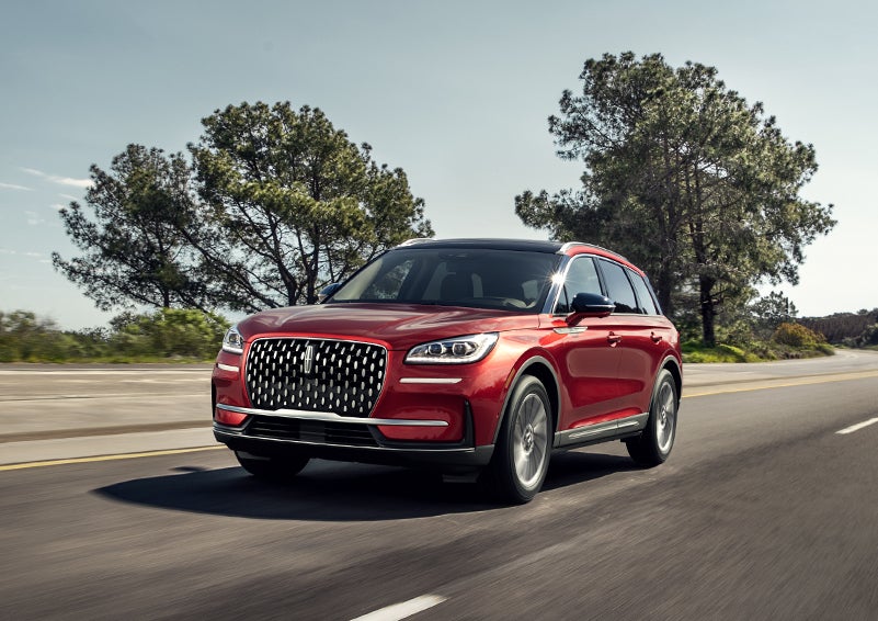 A 2024 Lincoln Corsair® SUV is shown being driven on a country road. | Parks Lincoln of Gainesville in Gainesville FL