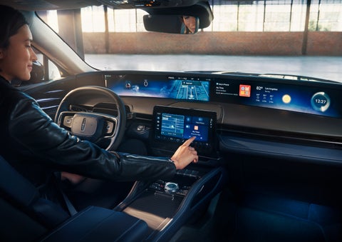 The driver of a 2024 Lincoln Nautilus® SUV interacts with the center touchscreen. | Parks Lincoln of Gainesville in Gainesville FL