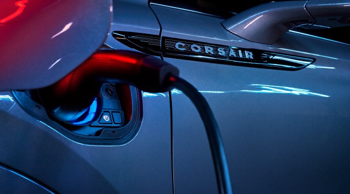 A charger plugged into the charging port of a 2024 Lincoln Corsair® Plug-in Hybrid model. | Parks Lincoln of Gainesville in Gainesville FL
