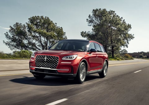 A 2025 Lincoln Corsair® SUV is shown being driven on a country road. | Parks Lincoln of Gainesville in Gainesville FL