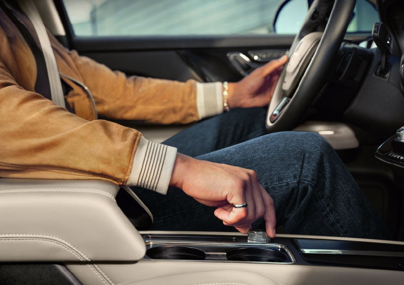 The driver of a 2024 Lincoln Corsair® SUV is shown selecting the drive mode. | Parks Lincoln of Gainesville in Gainesville FL