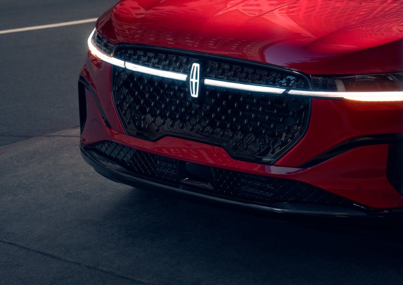 The available front LED light bar and center Lincoln Star logo glow at dusk. | Parks Lincoln of Gainesville in Gainesville FL