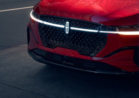 The available front LED light bar and center Lincoln Star logo glow at dusk. | Parks Lincoln of Gainesville in Gainesville FL