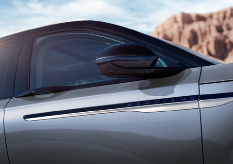 Blue lettering on the side of the vehicle that reads nautilus indicates the available hybrid powertrain. | Parks Lincoln of Gainesville in Gainesville FL