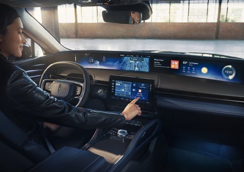 The driver of a 2026 Lincoln Nautilus® SUV interacts with the center touchscreen. | Parks Lincoln of Gainesville in Gainesville FL
