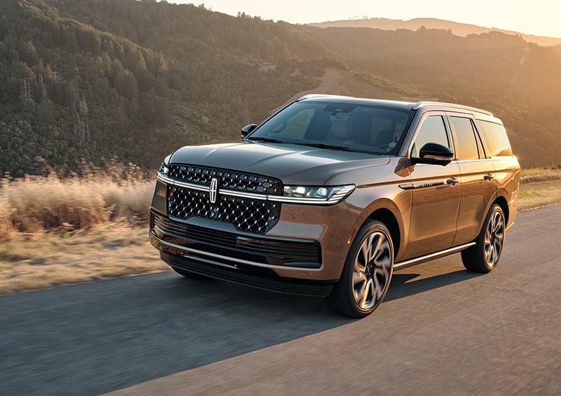 The Lincoln Star of a 2025 Lincoln Navigator® SUV is elegantly illuminated.