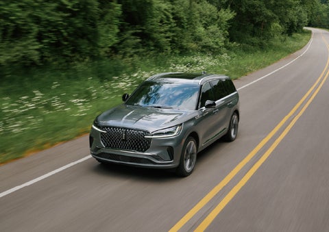 A 2027 Lincoln Aviator® SUV is being driven down a road. | Parks Lincoln of Gainesville in Gainesville FL