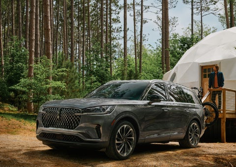 A 2027 Lincoln Aviator® is parked next to a high end glamping site. | Parks Lincoln of Gainesville in Gainesville FL