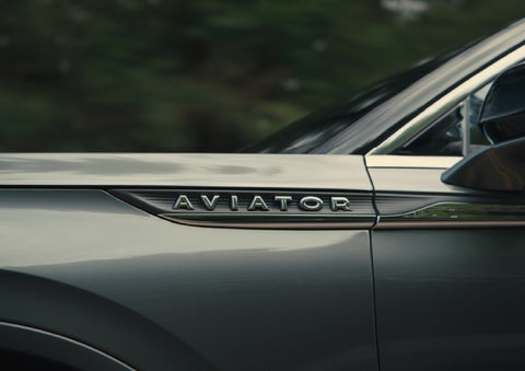 The driver’s side door and fender badging of a gray 2027 Lincoln Aviator® SUV are showcased. | Parks Lincoln of Gainesville in Gainesville FL