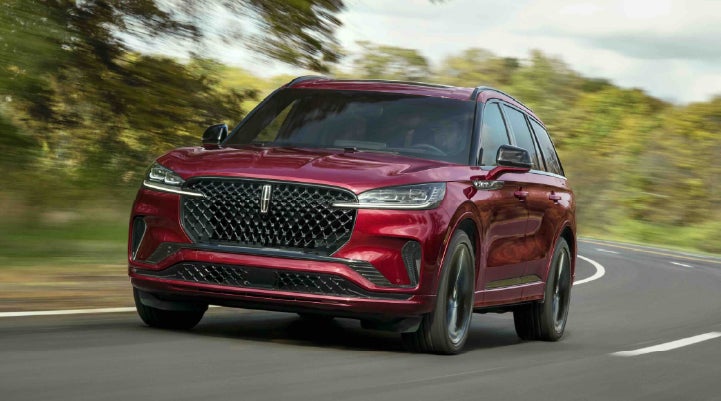 A 2027 Lincoln Aviator® SUV is being driven on a country road | Parks Lincoln of Gainesville in Gainesville FL