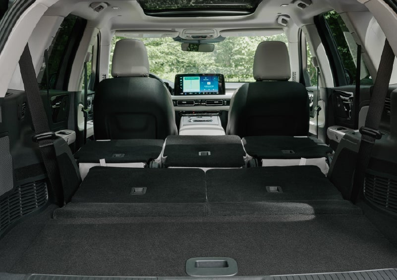 A rear to front view of the interior of a 2027 Lincoln Aviator® Black Label™ SUV shows the third and second rows folded flat | Parks Lincoln of Gainesville in Gainesville FL
