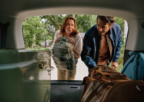 A couple loads luggage into the rear of a 2027 Lincoln Aviator® Black Label™ SUV..e 202 | Parks Lincoln of Gainesville in Gainesville FL